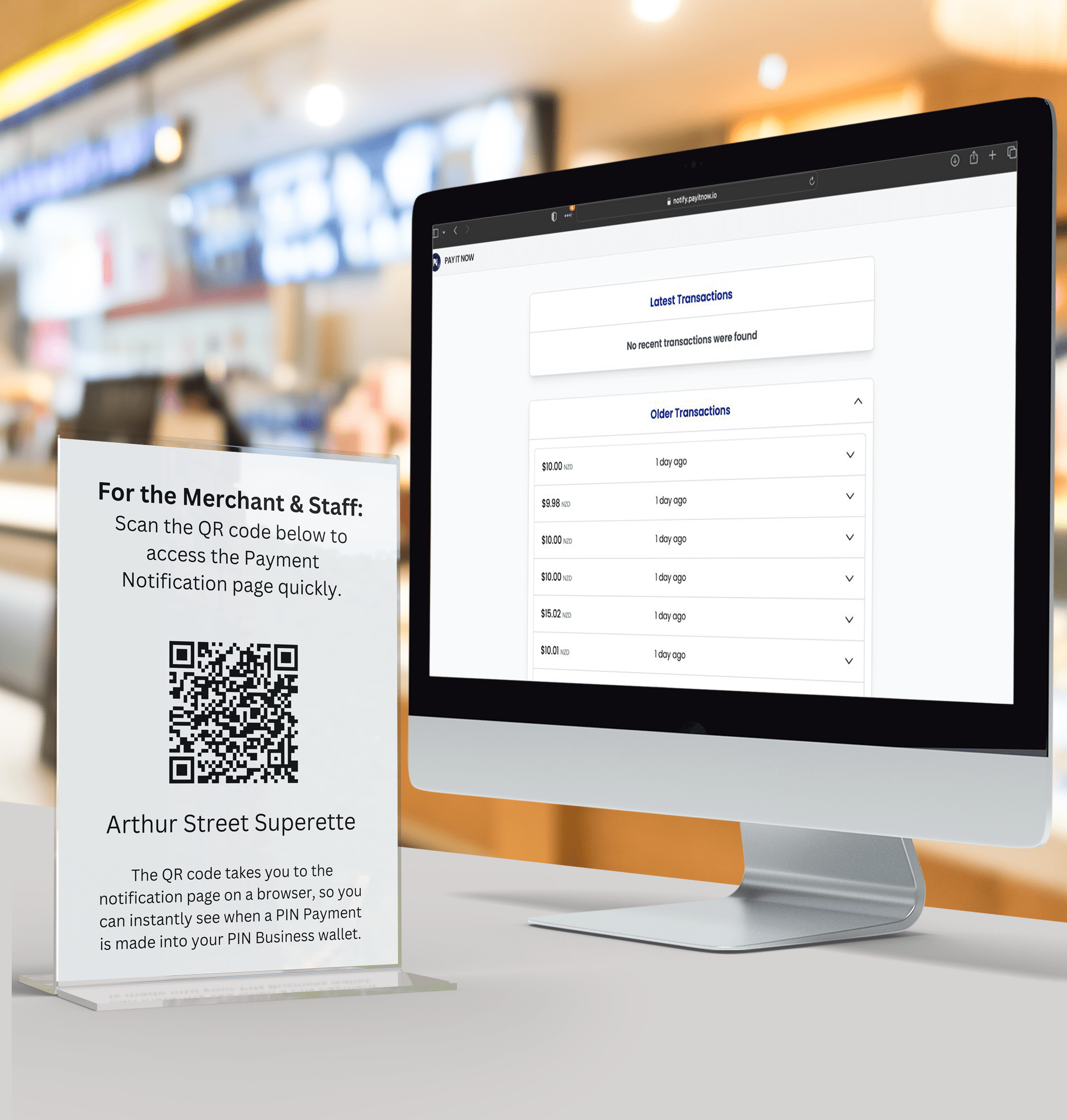 A Notify QR code stand next to a POS station in a store